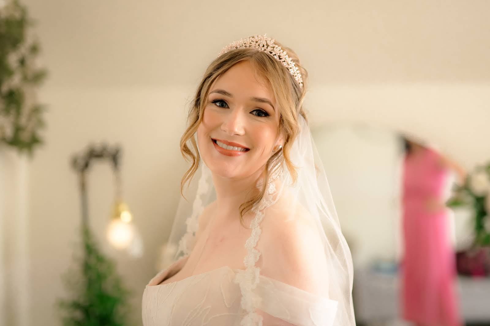 Bride in a cathedral veil and tiara with luminous soft glam makeup by Eleglam